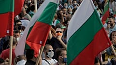 A protester seen behind flags whistles during anti-governmental protest in downtown Sofia on Monday, July 13, 2020.