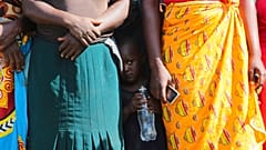 A child pictured in February standing between women waiting to receive food parcels in Zimbabwe, where the UN estimates more than half the population is in need of food assist