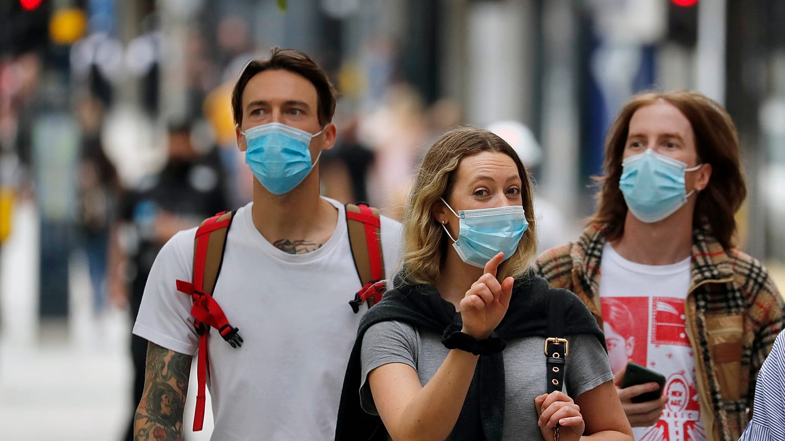 Shoppers wearing protective face masks walk along Oxford Street in London, Tuesday, July 14, 2020.