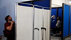 Medical staff conduct a test for the new coronavirus on the passengers who arrived from Doha, Qatar to the Eleftherios Venizelos International Airport in Athens, Monday, June 