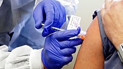A subject receives a shot in the first-stage safety study clinical trial of a potential vaccine by Moderna for COVID-19