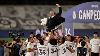 Real Madrid players throw head coach Zinedine Zidane in the air as they celebrate after winning the La Liga title.