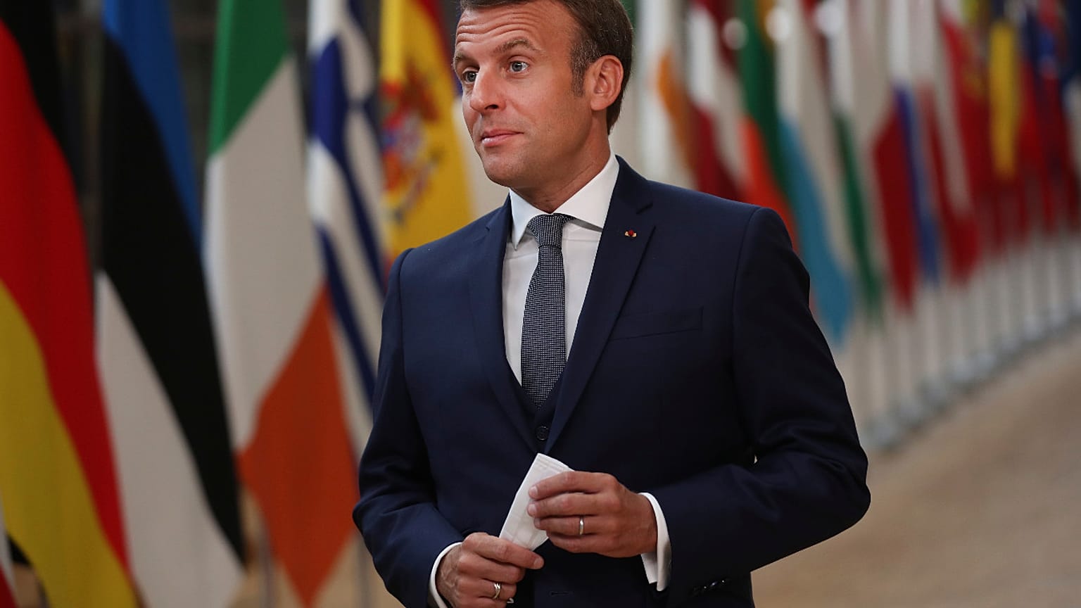 French President Emmanuel Macron makes a statement as he arrives for an EU summit at the European Council building in Brussels, Friday, July 17, 2020.