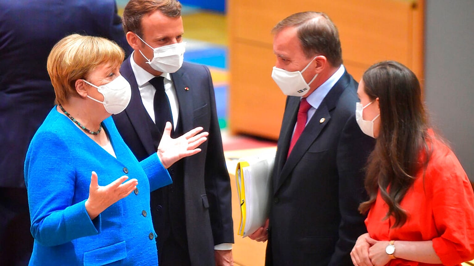 German Chancellor Angela Merkel and French President Emmanuel Macron speak with Sweden's Prime Minister Stefan Lofven and Finland's Prime Minister Sanna Marin