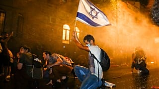 Israeli police use a water cannon to disperse people during a protest against Israeli Prime Minister Benjamin Netanyahu in Jerusalem, Saturday, July 18, 2020