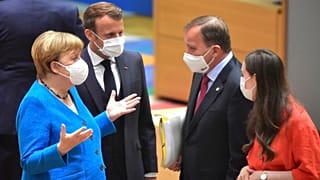 German Chancellor Angela Merkel, left, and French President Emmanuel Macron, second left, speak with Sweden's Prime Minister Stefan Lofven, second right, and Finland's Prime M