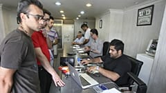 Iranians exchange currencies in a money exchange bureau, in downtown Tehran, Iran