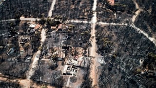 Burnt houses and trees following a wildfire in Mati, east of Athens