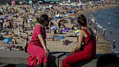 Two women look at the beach in Barcelona, Spain