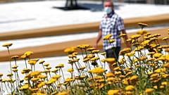 A man wearing a face mask to protect against coronavirus walks in downtown Belgrade, Serbia.