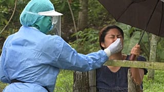 Toma de muestras nasales a una mujer para detectar la presencia de la COVID-19 en Panamá