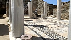 An Archaeological Service worker walks past marble columns on the island of Delos, an ancient center of religious and commercial life, in Greece, June 2020.