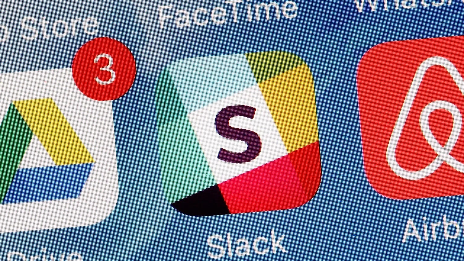 The Slack app is displayed on a mobile phone.