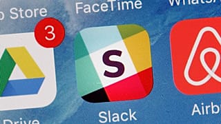The Slack app is displayed on a mobile phone.