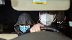 Nicolas Zepeda, centre right, is driven in a car by police investigators from his home, where he was under house arrest, one day prior his extradition to France.
