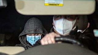 Nicolas Zepeda, centre right, is driven in a car by police investigators from his home, where he was under house arrest, one day prior his extradition to France.