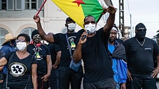 Masked protestors gathered in front of the Prefecture of Guiana during a meeting about the department's COVID-19 response.