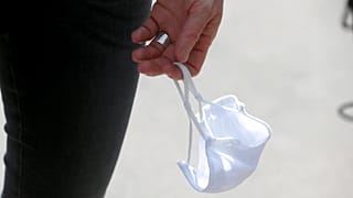 A person carries a face mask in Vienna, Austria, July 21, 2020. 