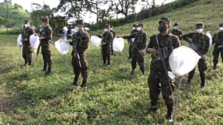 Un grupo de soldados recibe instrucciones antes de fumigar los campos