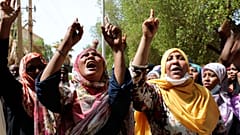 Protesters outside a court in Khartoum where former president Omar al-Bashir is on trial, July 21 2020.
