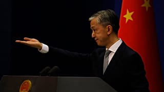Foreign Ministry spokesperson Wang Wenbin gestures for questions during a daily briefing in Beijing.