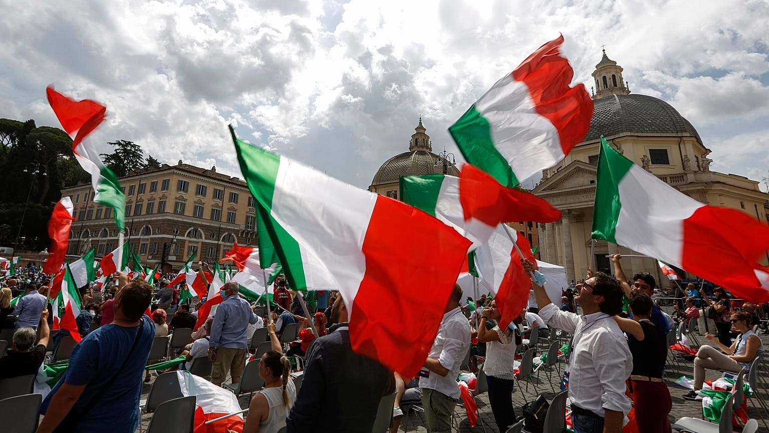 People wave Italian flags during a centre-right opposition rally in Rome's central Piazza del Popolo on July 4, 2020.