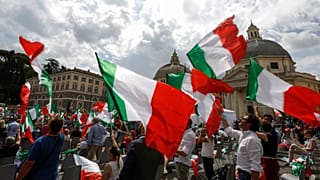 People wave Italian flags during a centre-right opposition rally in Rome's central Piazza del Popolo on July 4, 2020.