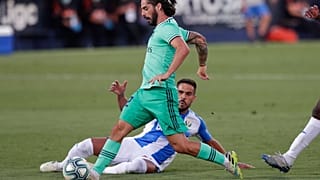 Real Madrid's Isco, is tackled by a Leganes' player during the Spanish La Liga soccer match between Leganes and Real Madrid.