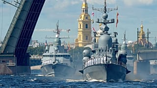 Russian warships sail on the Neva river during the Navy Day parade in Saint Petersburg.