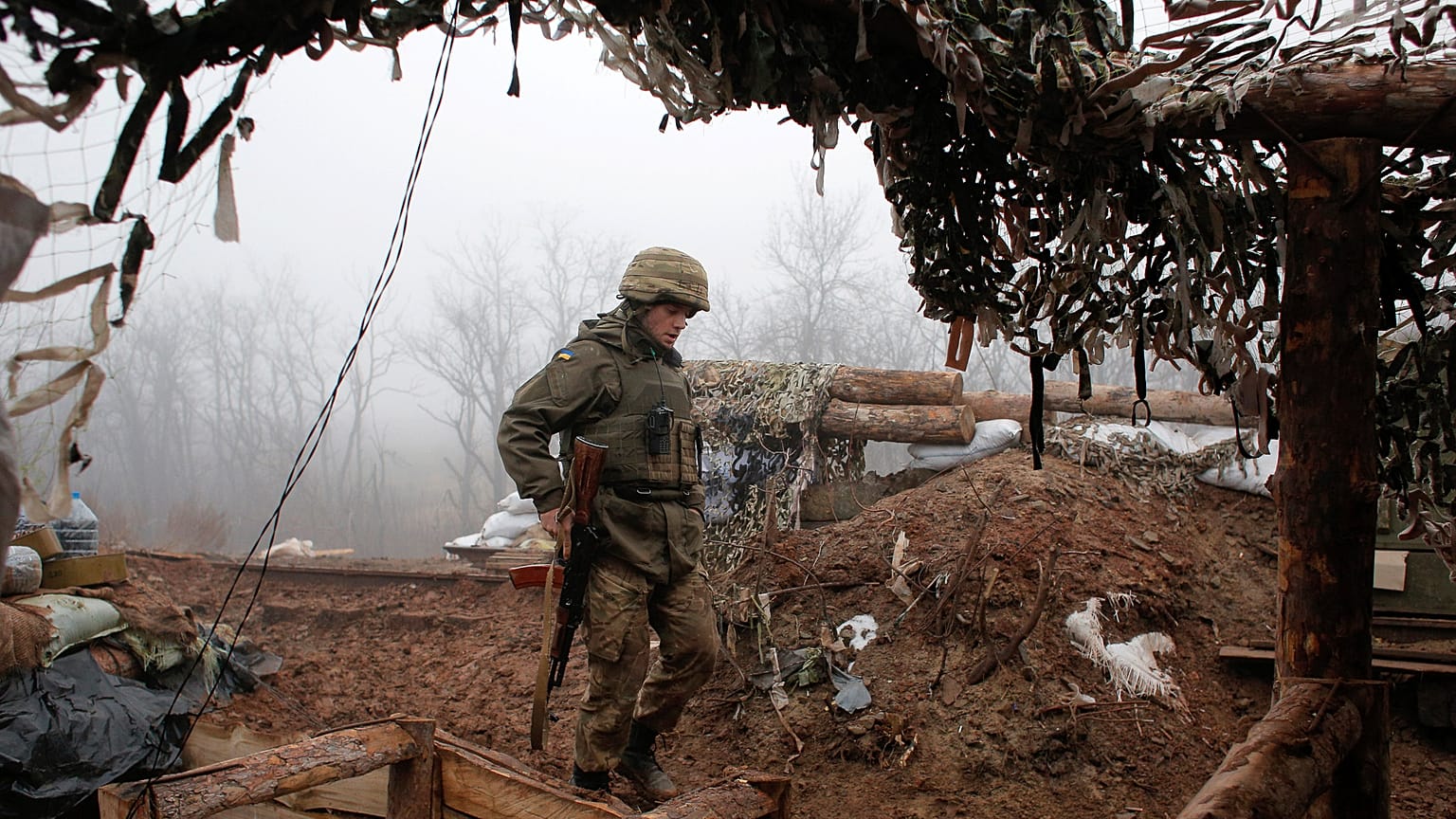 In this archive photo dated December 9, 2019, a Ukrainian soldier takes position on the front line at the town of Novoluhanske in the Donetsk region, Ukraine