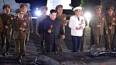North Korean leader Kim Jong Un, center, with military officers in uniforms prepares to lay a flower to the Fatherland Liberation War Martyrs' Cemetery in Pyongyang.
