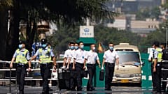 Chinese security personnel walk outside the United States Consulate in Chengdu in southwest China's Sichuan province on Monday, July 27, 2020