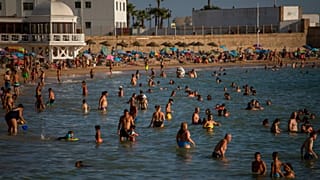 Bathers enjoy the beach in Cadiz, south of Spain, on Friday, July 24, 2020. 