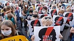 Protesters with a banner reading "Women's Strike" taking part in a rally against Polish government plans to withdraw from the Istanbul Convention on prevention and combatting 