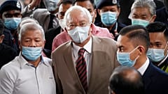 Former Malaysian Prime Minister Najib Razak, center, wearing a face mask with his supporters arrives at courthouse in Kuala Lumpur, Malaysia, Tuesday, July 28, 2020.
