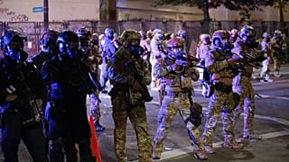 Federal officers begin dispersing a group of demonstrators during a Black Lives Matter protest Monday, July 27, 2020, in Portland, Oregon.