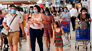 Customers wear face masks as they shop in a shopping mall in Anglet, southwestern France.