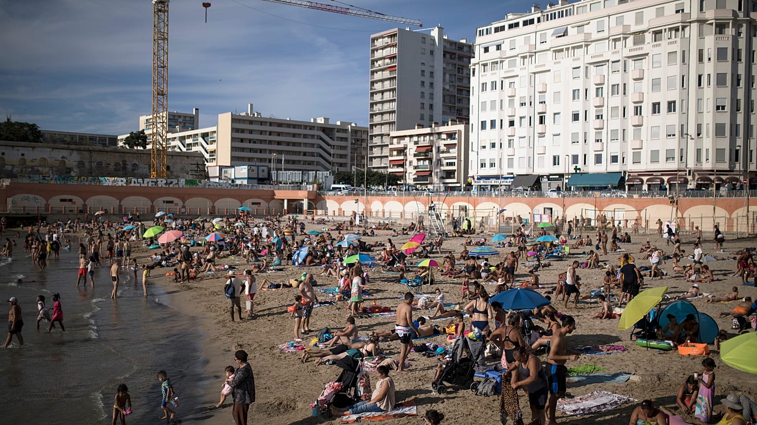 Beachgoers enjoy the sun at the Plage des Catalans in Marseille, southern France, July 25, 2020. 