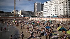 Beachgoers enjoy the sun at the Plage des Catalans in Marseille, southern France, July 25, 2020. 