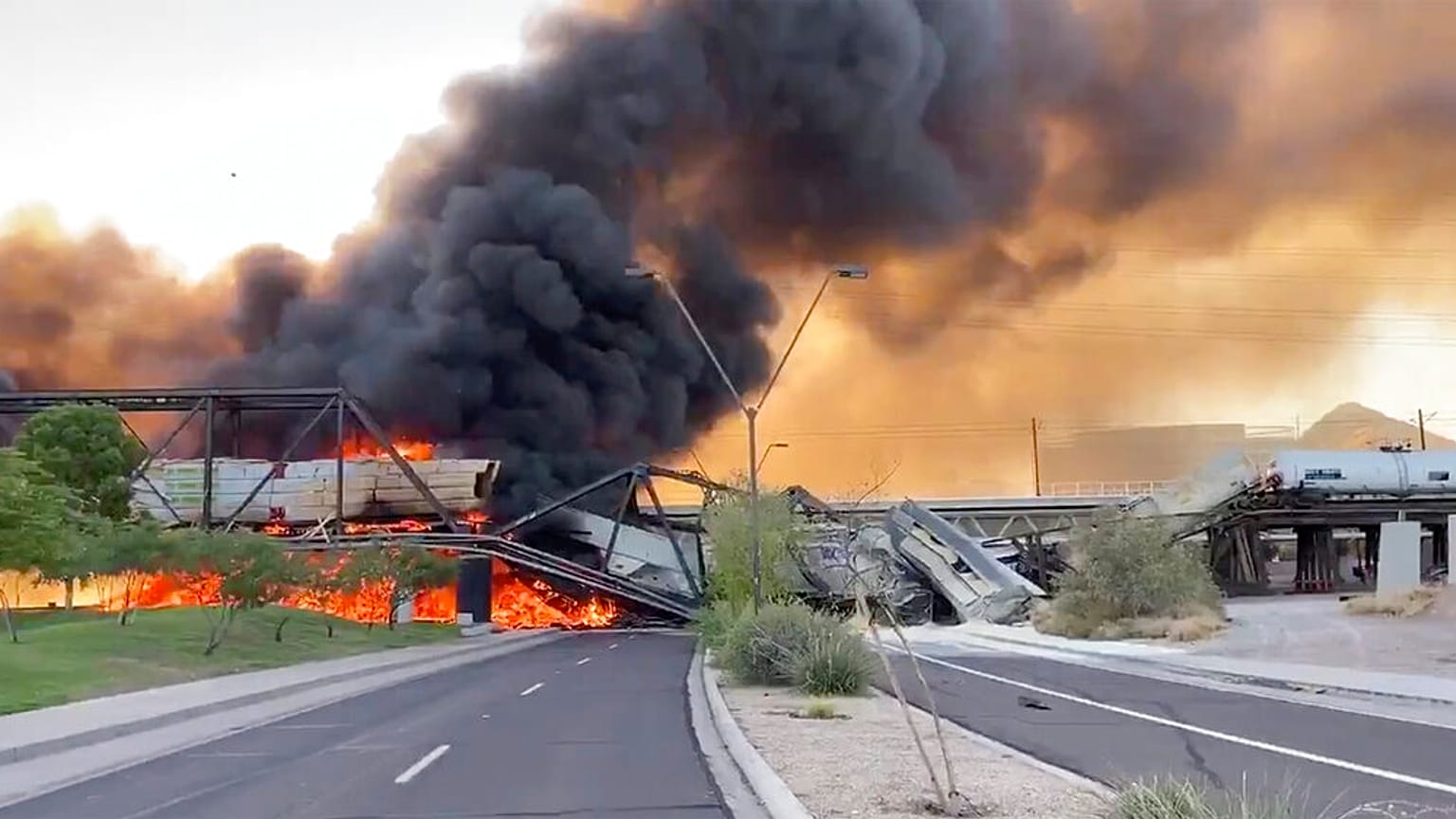 Smoke fills the sky at the scene of a train derailment in Tempe, Arizona