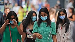 Shoppers wear face coverings to protect themselves from COVID-19 as they walk along Oxford Street in London, July 24, 2020. 