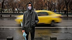 A man wears a mask during an anti-pollution protest outside the city hall in Bucharest, Romania
