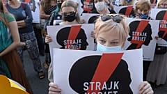 Women with the signs of "Women's Strike" rights organisation protest against Poland's plans to withdraw from Europe's Istanbul Convention.