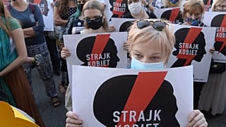 Women with the signs of "Women's Strike" rights organisation protest against Poland's plans to withdraw from Europe's Istanbul Convention.