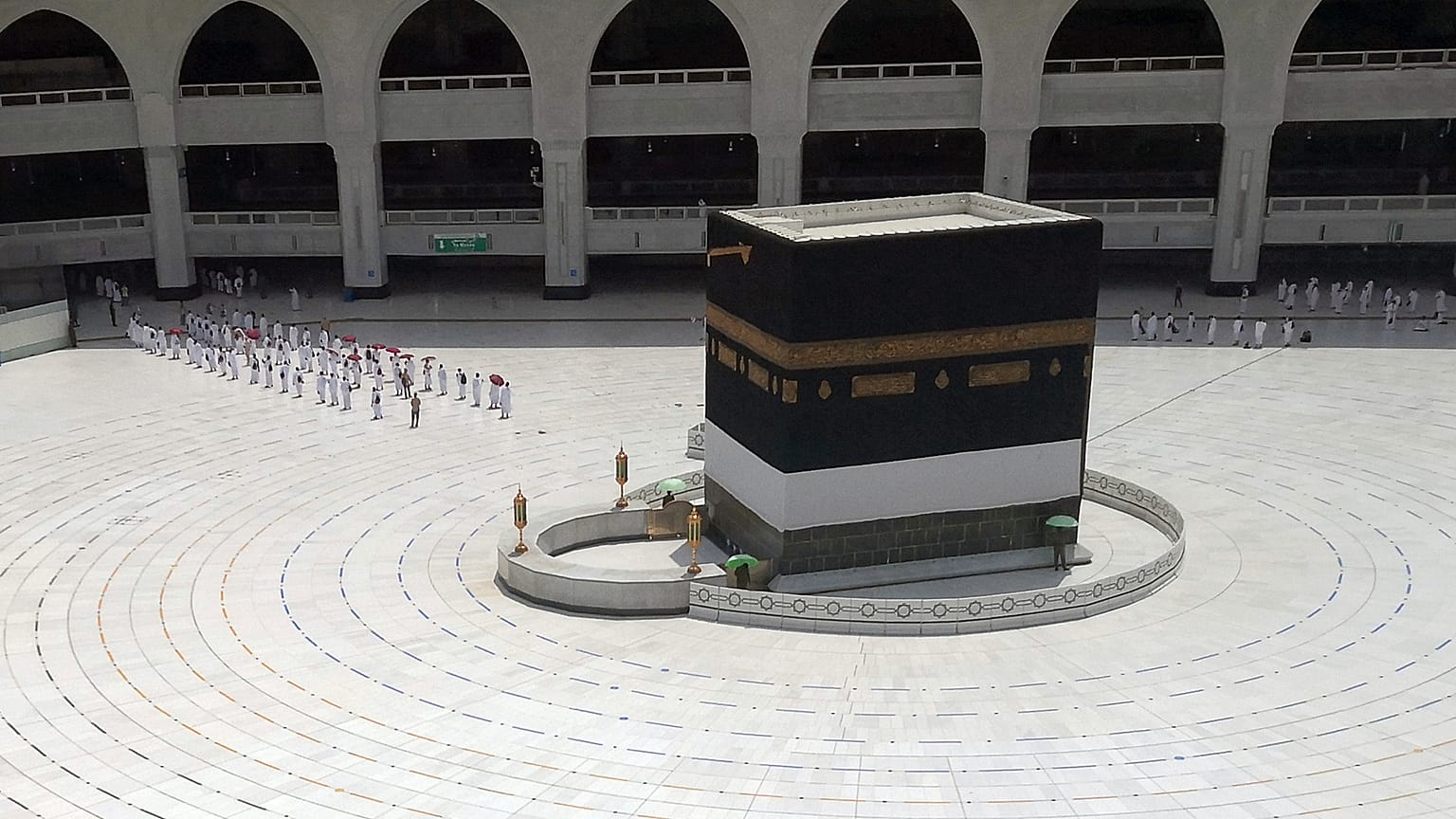 Muslim pilgrims line up to leave after they circled the Kaaba, the cubic building at the Grand Mosque,
