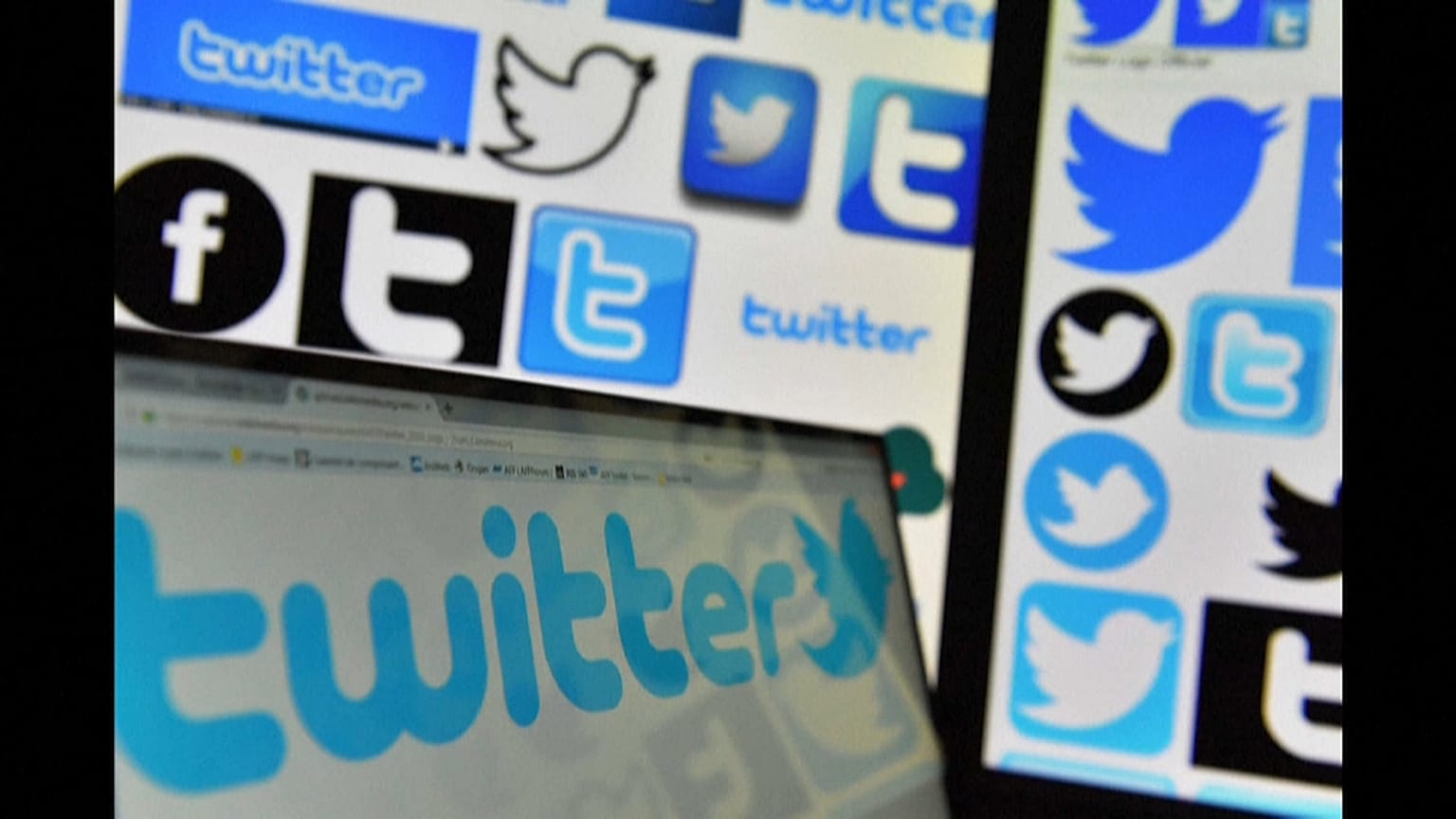 Logos of Twitter displayed on computers' screens