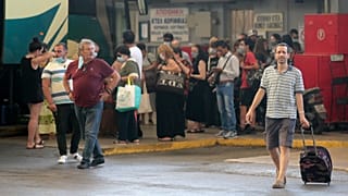 People boarding buses in Greece