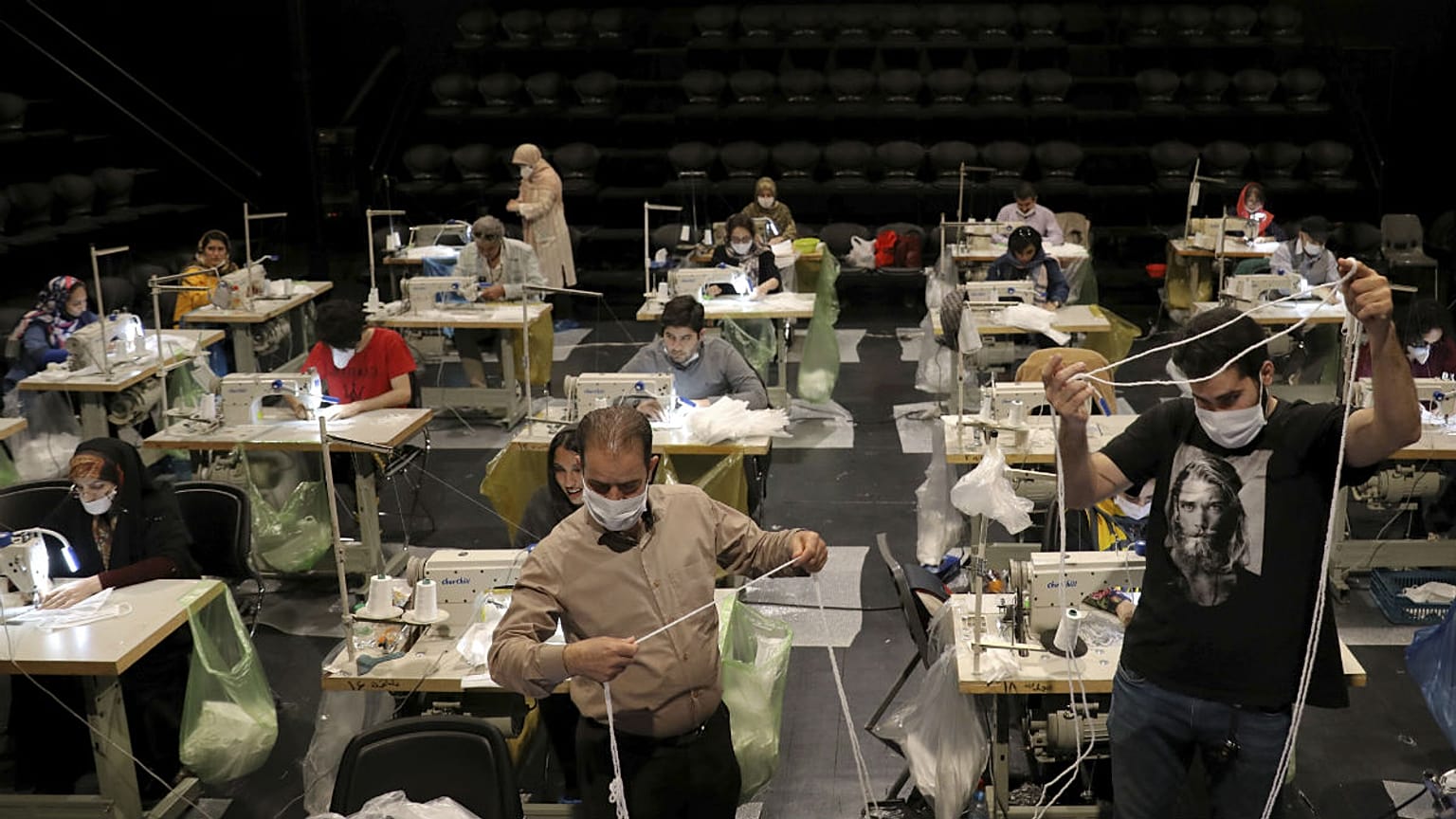 Volunteers wearing face masks to curb the spread of the new coronavirus, sew face masks for poor people, at the Hafez theatre hall in downtown Tehran, Iran