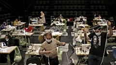 Volunteers wearing face masks to curb the spread of the new coronavirus, sew face masks for poor people, at the Hafez theatre hall in downtown Tehran, Iran