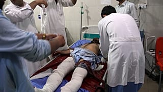A wounded man receives treatment at a hospital after a suicide car bomb and multiple gunmen attack in the city of Jalalabad, east of Kabul, Afghanistan, Sunday, Aug. 2, 2020.